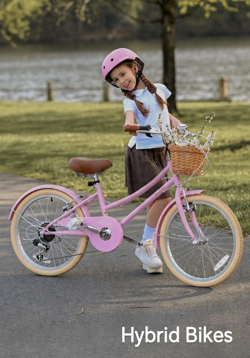 Girl in a pink helmet standing with a pink hybrid bike and flower-filled basket by a lake