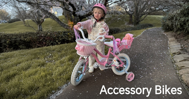 Toddler in a pink helmet with a pink training-wheel bike, front basket, and rear doll seat